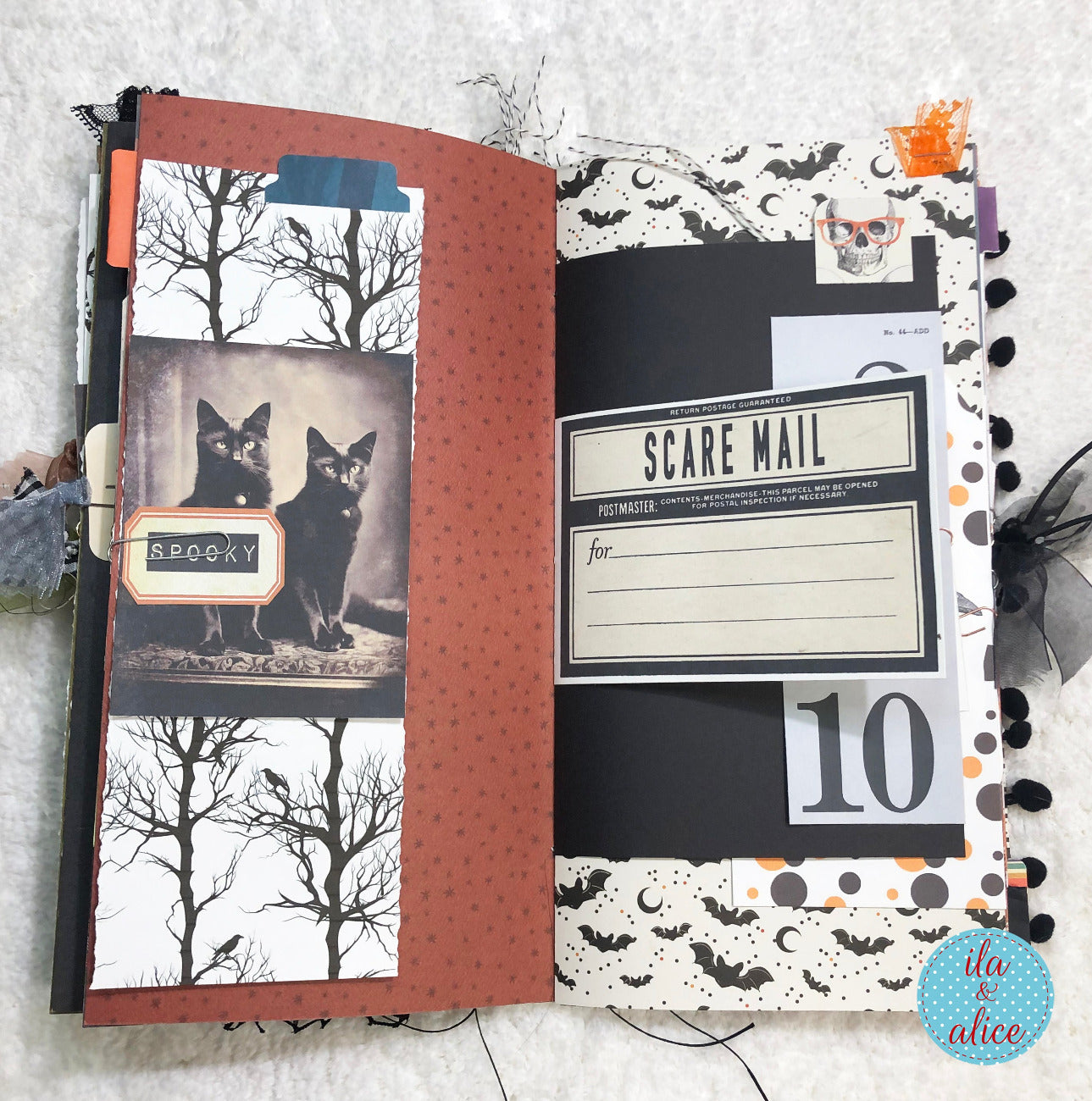 Handmade made Halloween junk journal  notebook with Halloween-themed pages featuring black cats and decorative text.