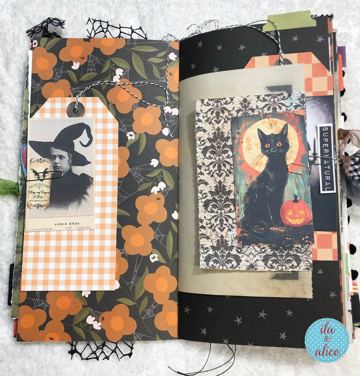 Handmade made Halloween junk journal  w Halloween-themed pages featuring a black cat and vintage-style illustrations.