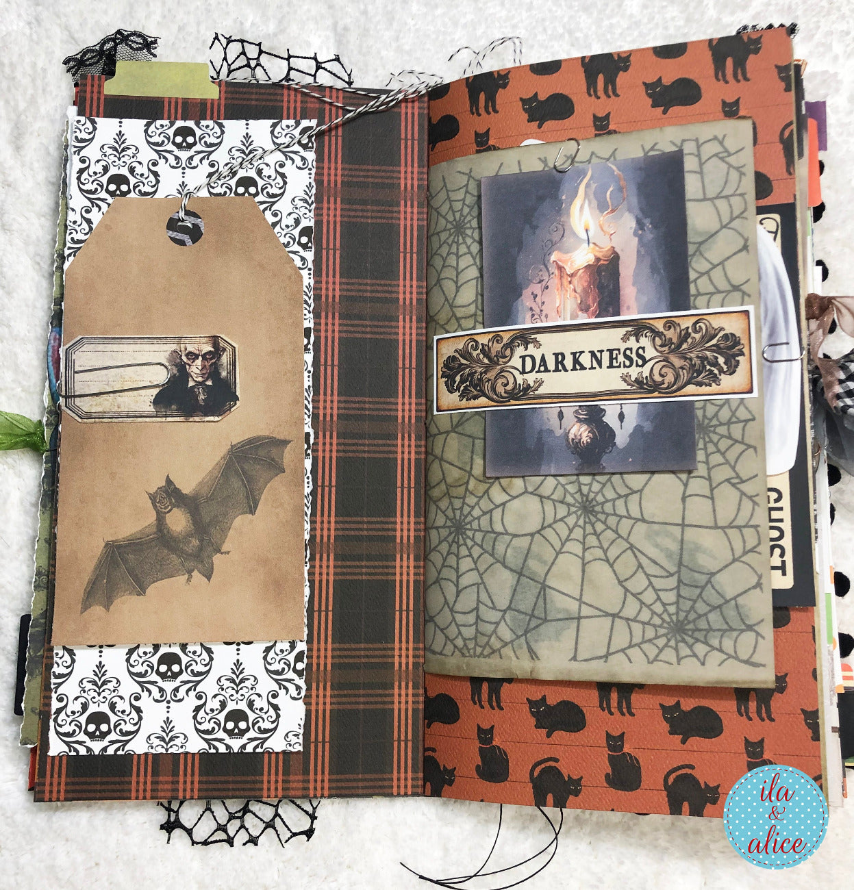 Handmade made Halloween junk journal  w Halloween-themed scrapbook page with spider web, bats, and cats.