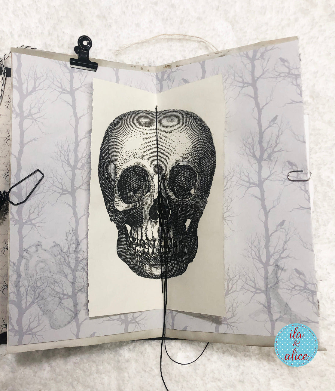 Open Halloween folio with a skull illustration on a white background