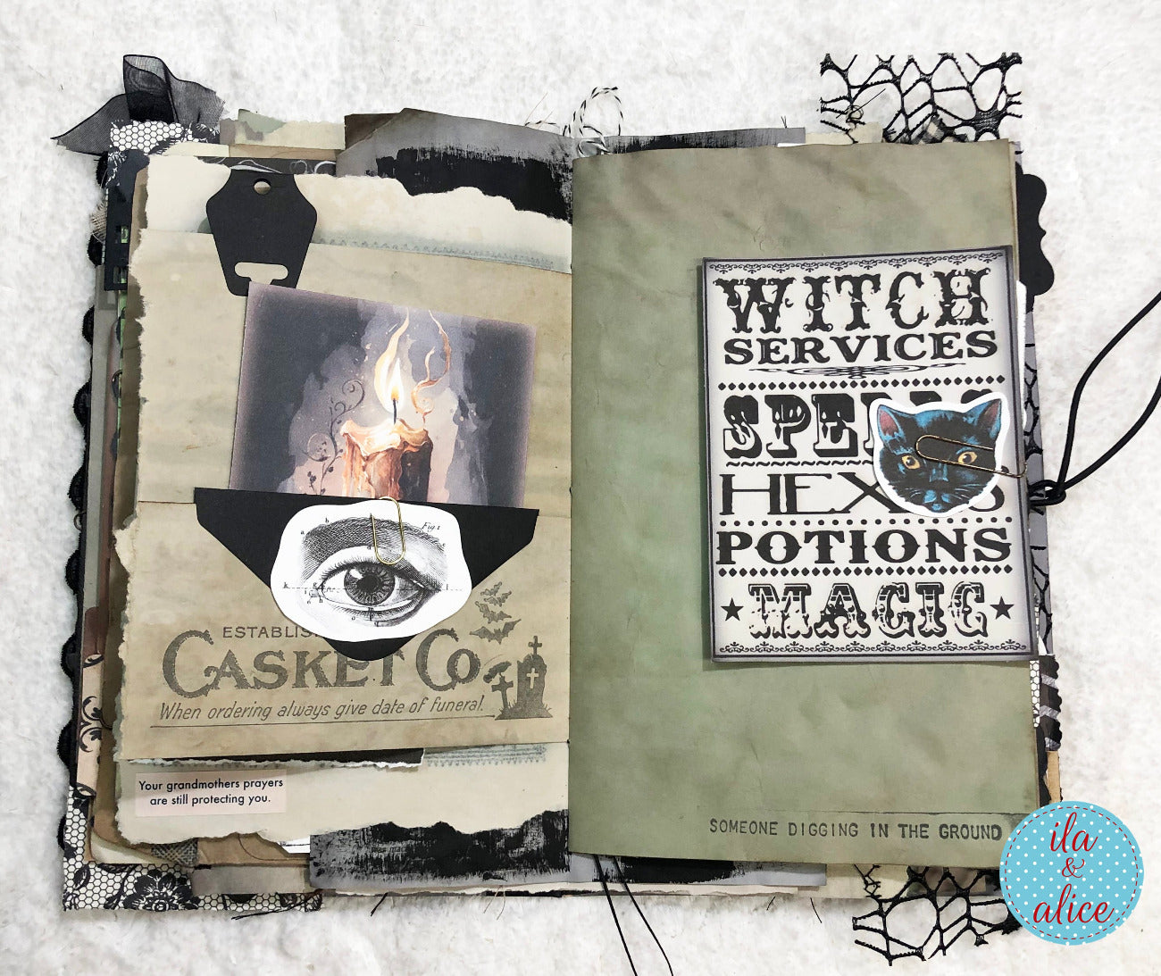 An open handmade journal or scrapbook album laid on a white textured fabric background. The pages feature gothic collage elements including torn paper, black lace, spiderweb cutouts, a candle illustration, an eye drawing, and text boxes reading 'WITCH SERVICES', 'SPELLS', 'POTIONS', and 'MAGIC'.