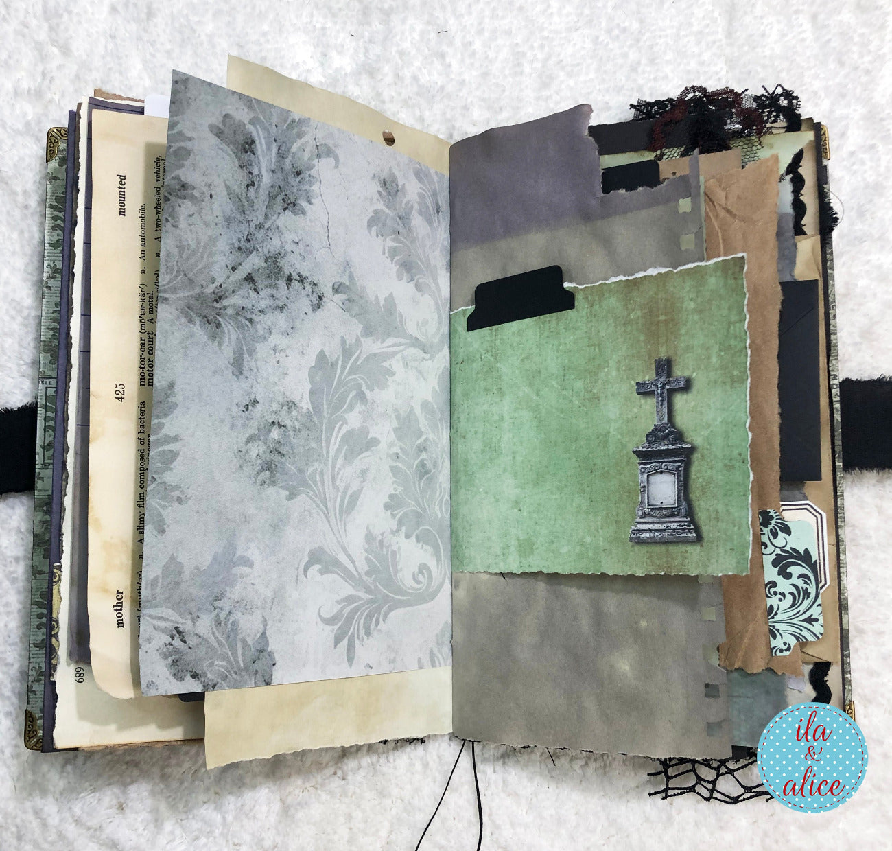 Handmade Eerie Halloween Gothic junk journal  with textured pages and a gravestone illustration on a textured surface.