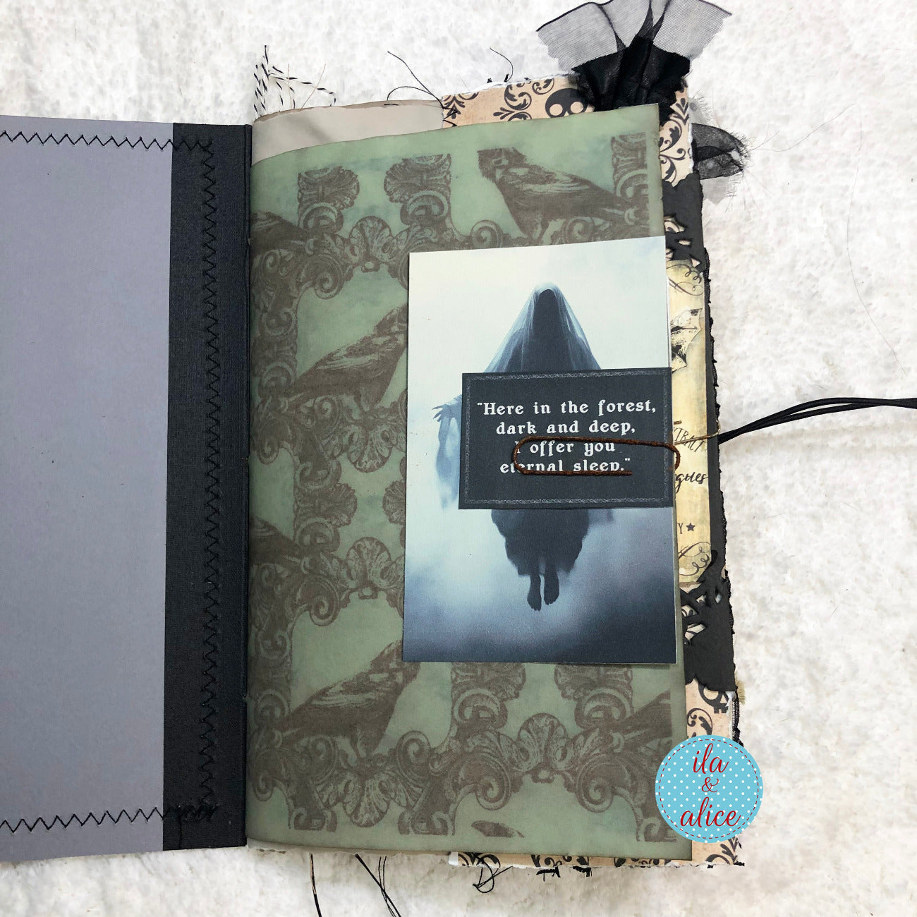 Handmade Halloween junk journal with a scary ghost and text on a textured surface