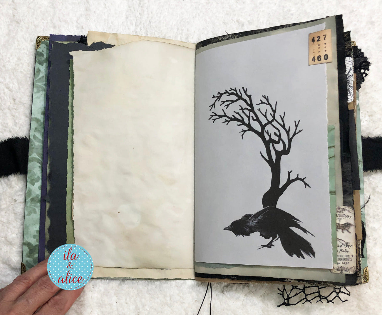 Handmade Eerie Halloween Gothic junk journal  with a black silhouette of a tree and a bird on a white background