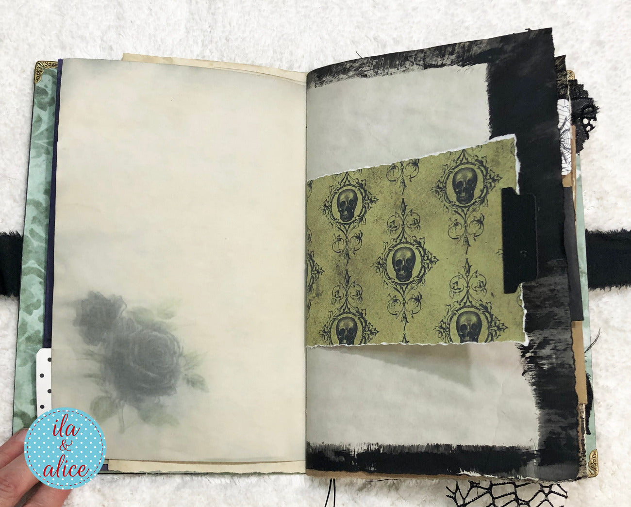 Handmade Eerie Halloween Gothic junk journal  with decorative pages featuring skull patterns and black and white design elements.