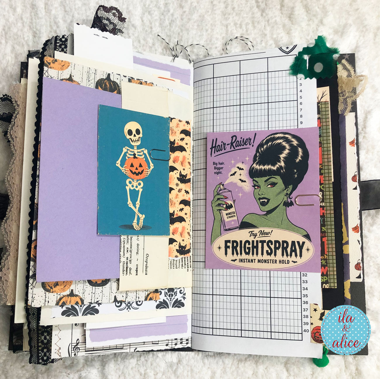 An open handmade scrapbook journal or planner featuring Halloween-themed embellishments, including a skeleton holding a pumpkin, patterned papers, purple sheets, and a vintage-style 'Frightspray' sticker on the right page.