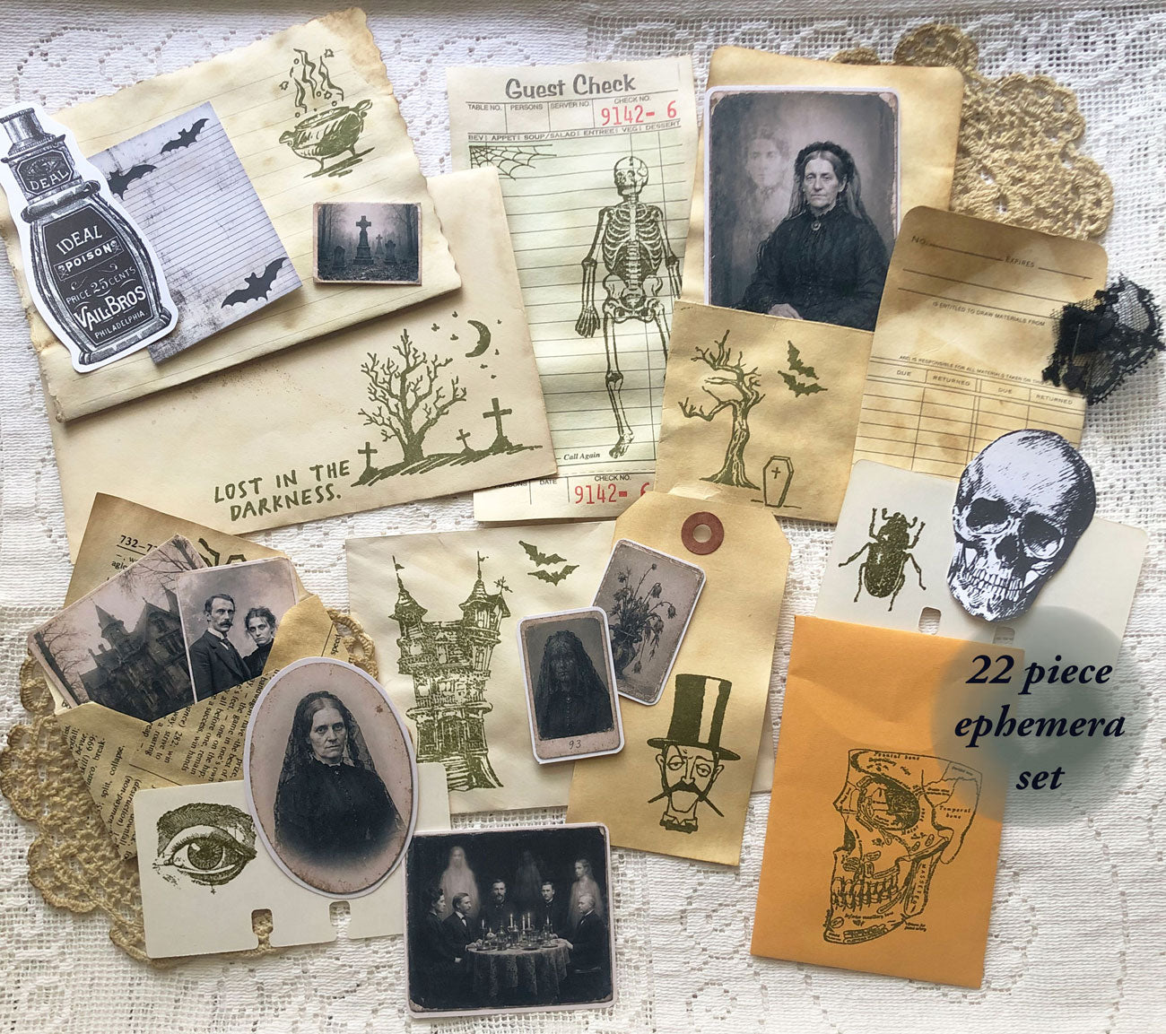 22 piece haunted ephemera set with coffee-dyed envelopes, gothic tags, stamped papers, and vintage-style photos.