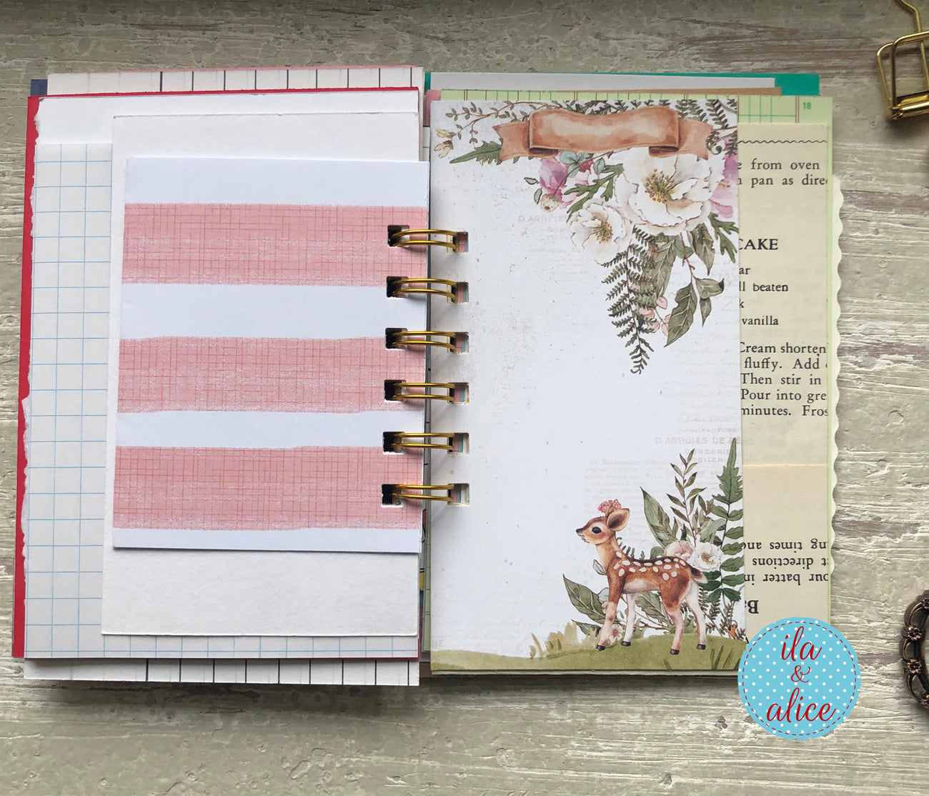 Planner with floral and deer design on a wooden surface, featuring the brand 'ila & alice'.