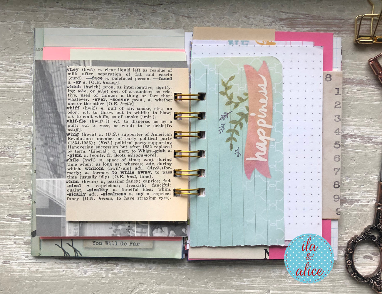 Planner with decorative pages and a key on a wooden surface