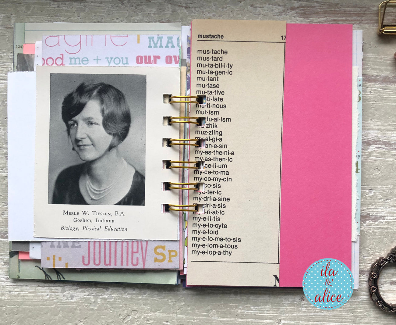 Planner or journal with a photo of a woman, text, and a pink page on a wooden surface.