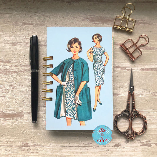 Mini handmade junk journal with vintage fashion illustration of women in blue dresses, spiral bound notebook