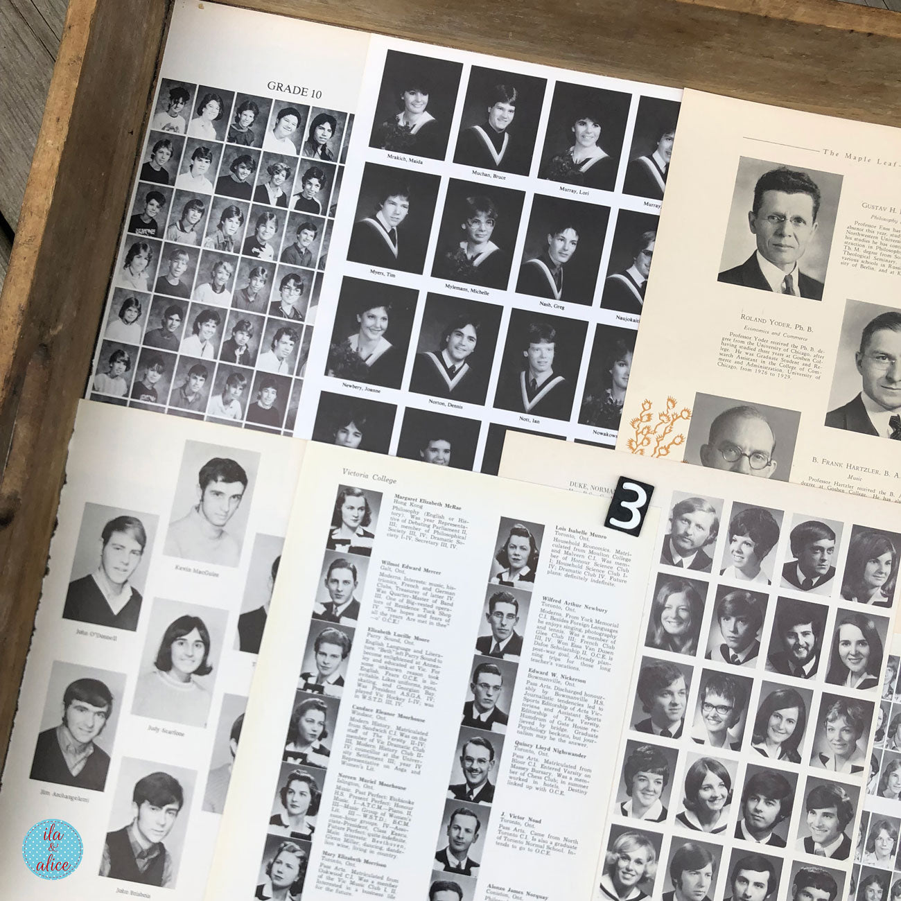 An open vintage yearbook spread displayed on a wooden surface, showing black-and-white portrait grids, student names, and printed pages.